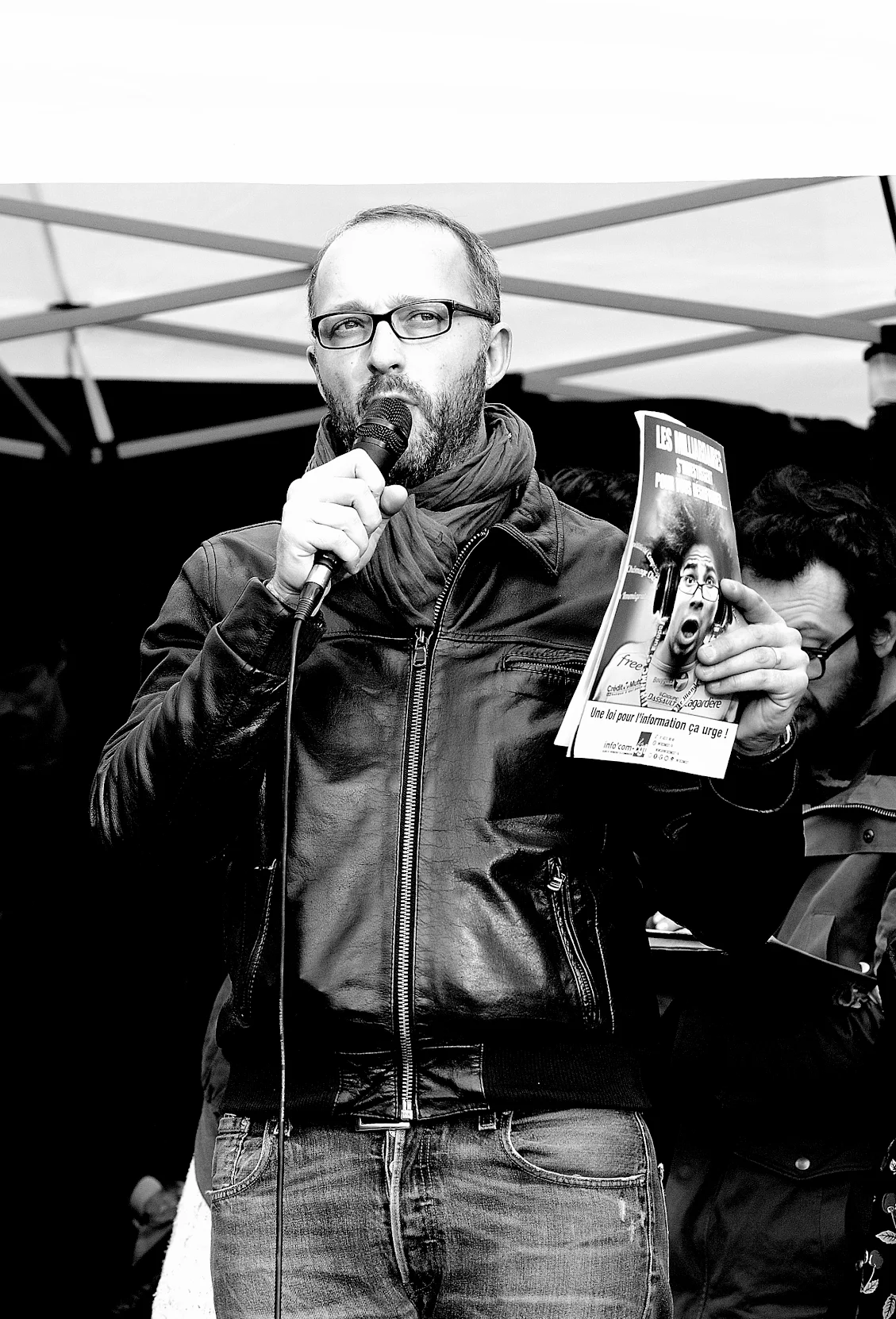 Militant brandissant un chèque géant de 15 000 € pour les cheminots de Versailles Chantiers.
